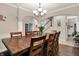 Formal dining area showcasing a large wood table, chandelier, and stylish archway at 5942 Tioga Ct, Bargersville, IN 46106