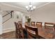 Formal dining area showcasing a large wood table, chandelier, and stylish archway at 5942 Tioga Ct, Bargersville, IN 46106