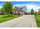 Two-story brick home with a large driveway and basketball hoop on a well-kept lawn at 5942 Tioga Ct, Bargersville, IN 46106
