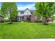 Beautiful brick home with a red door, manicured lawn, and lush landscaping at 5942 Tioga Ct, Bargersville, IN 46106