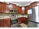 Well-lit kitchen features stainless steel appliances and ample cabinet storage at 5942 Tioga Ct, Bargersville, IN 46106