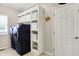 Neat laundry room with modern washer and dryer and ample storage shelves at 5942 Tioga Ct, Bargersville, IN 46106
