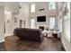 Open-concept living room with fireplace, sofas, and tall windows at 5942 Tioga Ct, Bargersville, IN 46106
