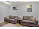 Basement living room area with two gray sofas, wood flooring, and neutral decor at 5942 Tioga Ct, Bargersville, IN 46106