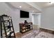 Finished basement featuring a TV, storage console, and laminate wood flooring at 5942 Tioga Ct, Bargersville, IN 46106