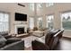 Bright living room with fireplace, mounted TV, and two sofas at 5942 Tioga Ct, Bargersville, IN 46106