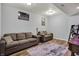 Basement living room area with two gray sofas, wood flooring, and neutral decor at 5942 Tioga Ct, Bargersville, IN 46106