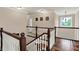 Second floor loft with hardwood floors, wood railing and view to window with chandelier at 5942 Tioga Ct, Bargersville, IN 46106