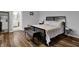 Main bedroom with wood floors, black furniture and view to Primary bathroom at 5942 Tioga Ct, Bargersville, IN 46106