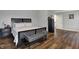 Main bedroom featuring wood floors, a bench, and a view of the entry to the en-suite bathroom at 5942 Tioga Ct, Bargersville, IN 46106
