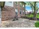Charming brick patio with chairs and a stone retaining wall, perfect for outdoor relaxation at 5942 Tioga Ct, Bargersville, IN 46106