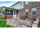 Outdoor patio with brick walls, access to a screened-in porch, and comfortable seating at 5942 Tioga Ct, Bargersville, IN 46106