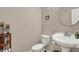 Cozy powder room featuring a pedestal sink, toilet, and decorative corner shelving at 5942 Tioga Ct, Bargersville, IN 46106
