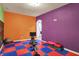 Spacious recreation room with colorful walls, rubber flooring, and exercise machine at 5942 Tioga Ct, Bargersville, IN 46106