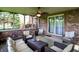 Cozy screened-in porch with wicker furniture, brick accents, and a fan for comfortable outdoor living at 5942 Tioga Ct, Bargersville, IN 46106