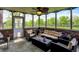 Cozy screened porch with wicker furniture, brick accents, and outdoor lighting at 5942 Tioga Ct, Bargersville, IN 46106
