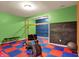 Finished basement gym area with a wall-mounted ladder, workout machine, and free weights at 5942 Tioga Ct, Bargersville, IN 46106