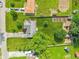 Well-manicured lawn in this aerial view features a garden, play set, garage and patio on this single Gathering property at 5987 E 100 N, Franklin, IN 46131