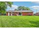 Expansive backyard featuring lush green lawn, patio seating, and a well-maintained brick home at 5987 E 100 N, Franklin, IN 46131