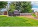 Beautifully landscaped backyard with a shed, playhouse, and garden, ideal for Gathering fun and gardening at 5987 E 100 N, Franklin, IN 46131
