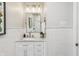 Stylish bathroom featuring subway tile, a marble vanity, and elegant lighting fixtures at 5987 E 100 N, Franklin, IN 46131
