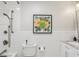 Bright bathroom with a subway tile surround, a framed floral picture, and modern fixtures at 5987 E 100 N, Franklin, IN 46131