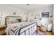 Comfortable bedroom features a metal frame bed, wooden nightstand, dresser, and sitting area at 5987 E 100 N, Franklin, IN 46131