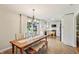 Dining room with wooden table and bench seating next to a bright, modern kitchen at 5987 E 100 N, Franklin, IN 46131