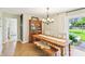 Charming dining area with a wooden table, bench seating, and a view of the backyard at 5987 E 100 N, Franklin, IN 46131