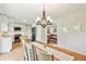 Bright dining area featuring a wood table with a chandelier and an open view into the kitchen at 5987 E 100 N, Franklin, IN 46131