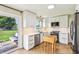 Well-lit kitchen with white cabinets, stainless steel appliances, and a view to the backyard at 5987 E 100 N, Franklin, IN 46131