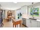 Sunlit kitchen with white cabinets, stainless steel appliances, and backyard views at 5987 E 100 N, Franklin, IN 46131