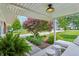 Inviting front porch with a red maple tree, cushioned seating, and well-manicured landscaping at 5987 E 100 N, Franklin, IN 46131