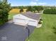 Aerial view of the outbuilding with three garage doors and basketball hoop in a large yard at 6086 W 850 S, Edinburgh, IN 46124