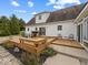 Backyard showcasing wooden deck, sliding doors, white siding, mature trees and landscaping at 6086 W 850 S, Edinburgh, IN 46124