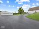 Long driveway leading to main house and outbuilding with multiple garage doors and a basketball hoop at 6086 W 850 S, Edinburgh, IN 46124