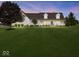 Charming two-story home with a large front yard and inviting porch at dusk at 6086 W 850 S, Edinburgh, IN 46124