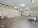 Large empty garage with white walls and floor with a golf cart at 6086 W 850 S, Edinburgh, IN 46124