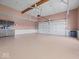 Spacious three car garage with epoxy floors, high ceilings and walls painted in neutral colors at 6086 W 850 S, Edinburgh, IN 46124