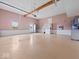 Large, neutral colored garage with high ceiling, lots of natural light, and access door to backyard at 6086 W 850 S, Edinburgh, IN 46124