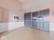 Garage with epoxy floors, white wainscoting and gray cabinets with aluminum trim at 6086 W 850 S, Edinburgh, IN 46124