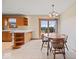 Eat-in kitchen with a tile floor, ample wood cabinets, and a cozy dining area at 6086 W 850 S, Edinburgh, IN 46124
