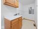 Bright laundry room with upper and lower cabinets, white countertop, tile floor and built-in ironing board at 6086 W 850 S, Edinburgh, IN 46124