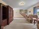 Spacious living room with carpeting, built-in wood entertainment center, and natural light at 6086 W 850 S, Edinburgh, IN 46124