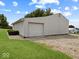 Outbuilding with a single garage door next to gravel and grass on a large lot at 6086 W 850 S, Edinburgh, IN 46124