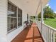 Relaxing covered porch with seating, features a painted wood floor and white railing at 6086 W 850 S, Edinburgh, IN 46124