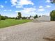 Large property with long gravel driveway leading to the main house and outbuilding at 6086 W 850 S, Edinburgh, IN 46124