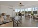 Bright sunroom featuring wood flooring, large windows, white shiplap and comfortable seating at 6086 W 850 S, Edinburgh, IN 46124