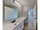 Bathroom with a white vanity, a large mirror, and wood-look flooring at 6420 Greenspire Pl, Indianapolis, IN 46221