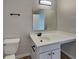 Bathroom featuring a white vanity, toilet, and a large mirror at 6420 Greenspire Pl, Indianapolis, IN 46221